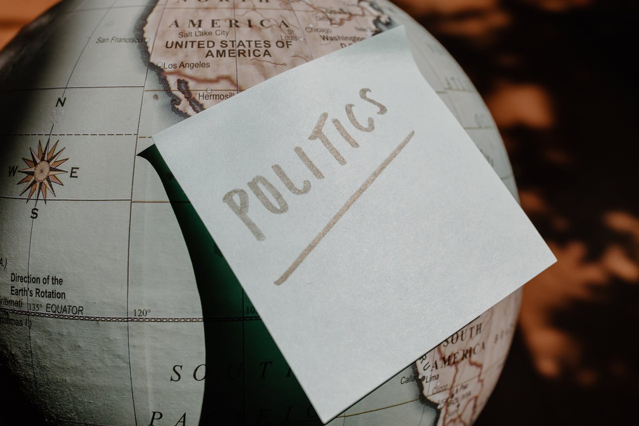 Services A close-up of a globe with a politics sticky note, symbolizing global political themes.